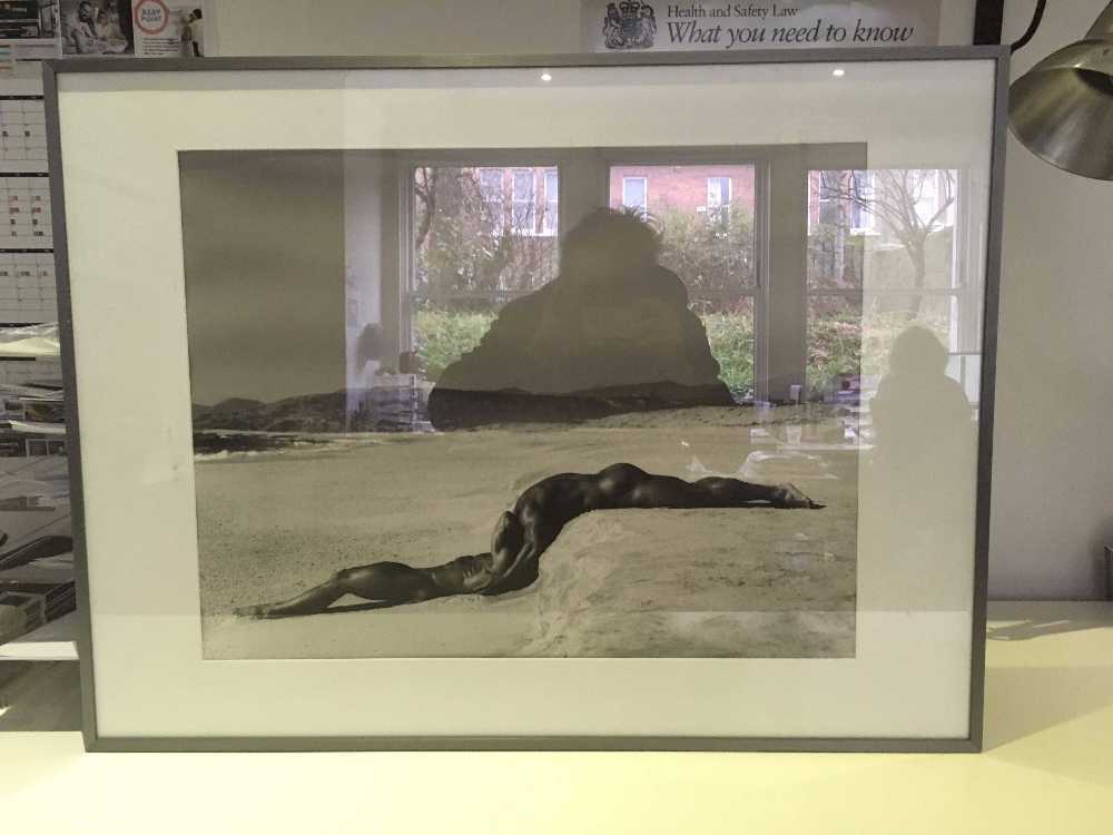 Framed photograph of nudes on a beach in london